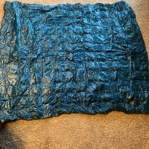 Blue Ridge teal packable down throw.